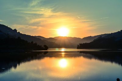 Scenic view of douro river against sky during sunrise