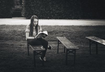 Full length of woman sitting on bench