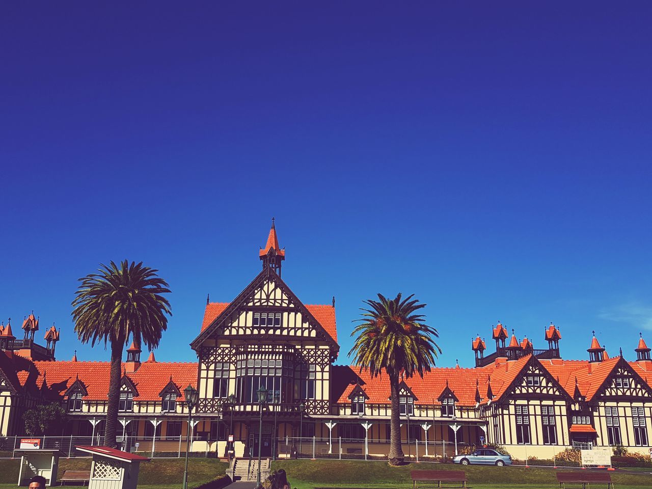 architecture, built structure, building exterior, sky, blue, clear sky, building, copy space, tree, nature, palm tree, city, plant, no people, travel destinations, residential district, day, house, arts culture and entertainment, outdoors