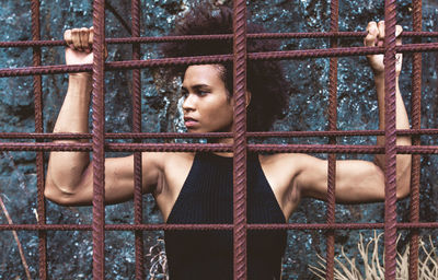 Portrait of young man in cage