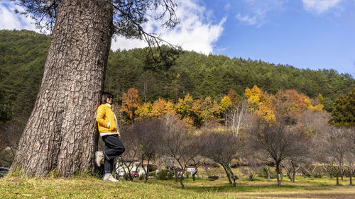 Rear view of woman walking on field