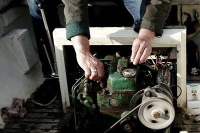 Close-up of man checking machinery