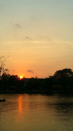 Scenic view of lake against romantic sky at sunset