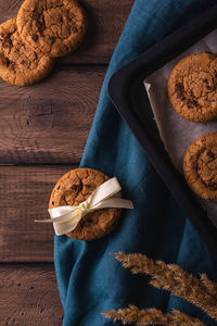 Chocolate cookies on a wooden table decorated with a blue napkin