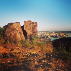 Rock formations on landscape against clear sky