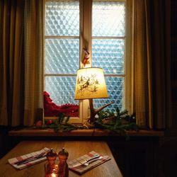 Man standing by window at home