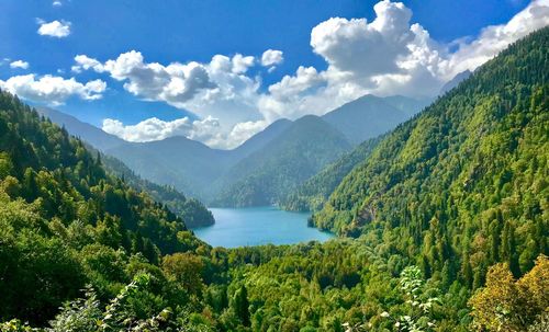 Scenic view of river amidst mountains against sky