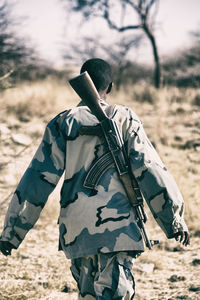 Rear view of man standing on field