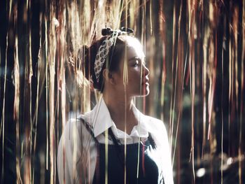 Woman amidst decorations looking away