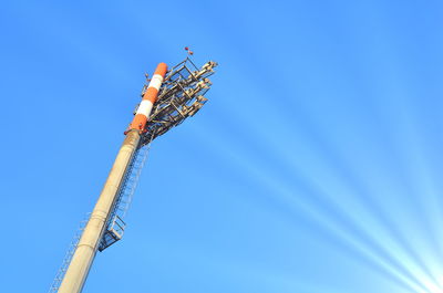 Low angle view of crane against clear blue sky