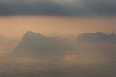 Scenic view of silhouette mountains against sky during sunset