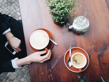 Cropped image of hand holding coffee cup