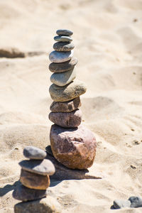 Stack of pebbles on sand at beach