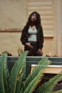 Shadow of woman sitting on plant