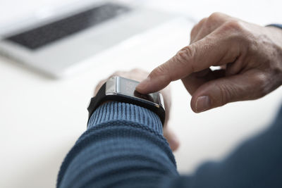 Smart watch on arm of mature man