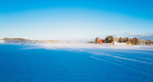 Scenic view of sea against clear blue sky
