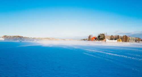 Scenic view of sea against clear blue sky