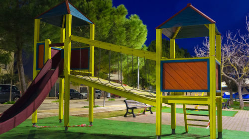 Playground in park against sky