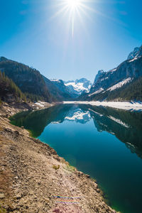 Scenic view of lake and mountains against sky