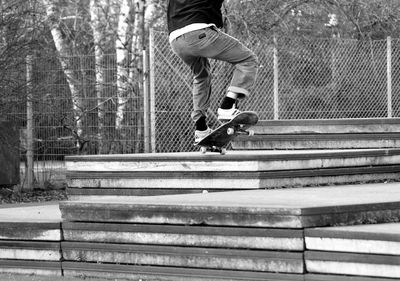 Low section of man skateboarding in park