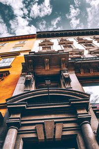 Low angle view of building against cloudy sky