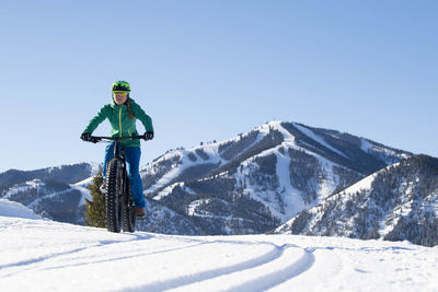 A woman riding her fat bike on a beautiful winter day in sun valley.