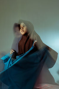 Blurred motion of girl holding fabric