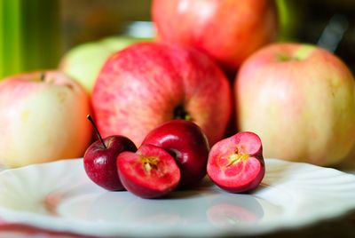 Close-up of small apples in plate
