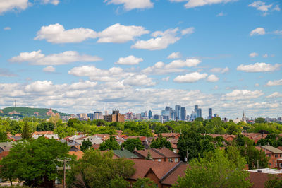 High angle view of trees and buildings against sky