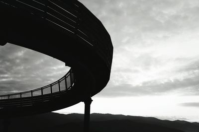 Low angle view of bridge over river against sky