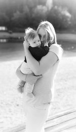 Mother with baby girl standing outdoors