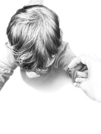 High angle view of hands over white background