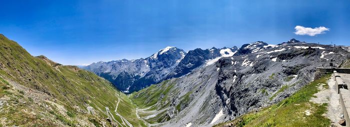 Panoramic view of snowcapped mountains against clear blue sky