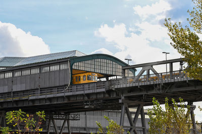 Low angle view of train on bridge against sky