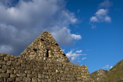 Low angle view of old ruins against blue sky