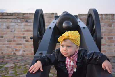 Portrait of boy wearing sunglasses against brick wall