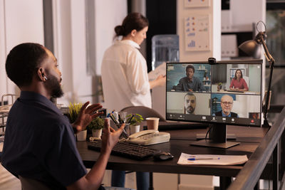 Rear view of business colleagues working at office