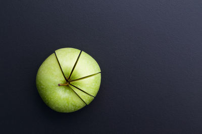 Directly above shot of granny smith apple on slate