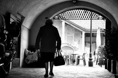 Rear view of woman walking in building