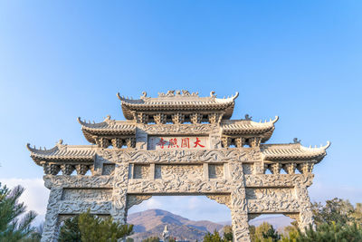 Low angle view of historic building against clear blue sky