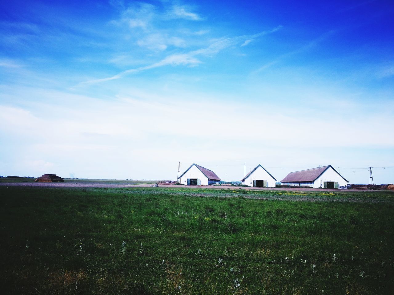 LIFEGUARD HUT ON FIELD AGAINST SKY