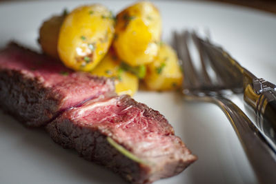 Close-up of steak in plate on table in restaurant