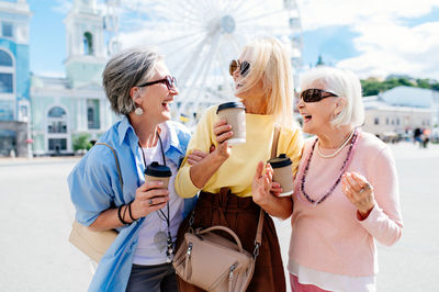 Female friends standing in city