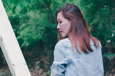 Side view of a young woman looking away