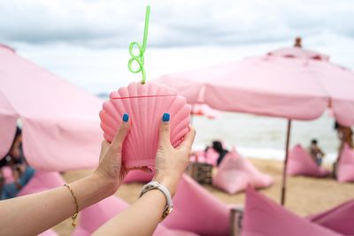 Close-up of hand holding pink flowers