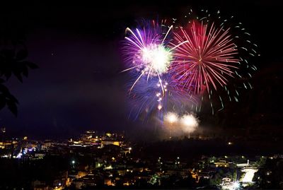 Low angle view of firework display in sky at night