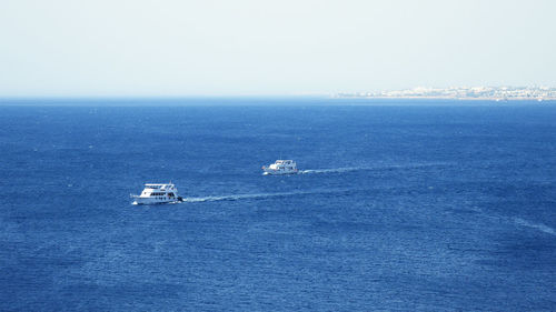 High angle view of ship sailing in sea against clear sky