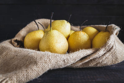 Close-up of pears in sack on table