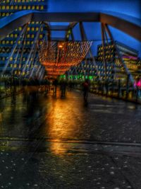 Illuminated city against sky at night