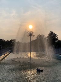 Scenic view of fountain against sky during sunset